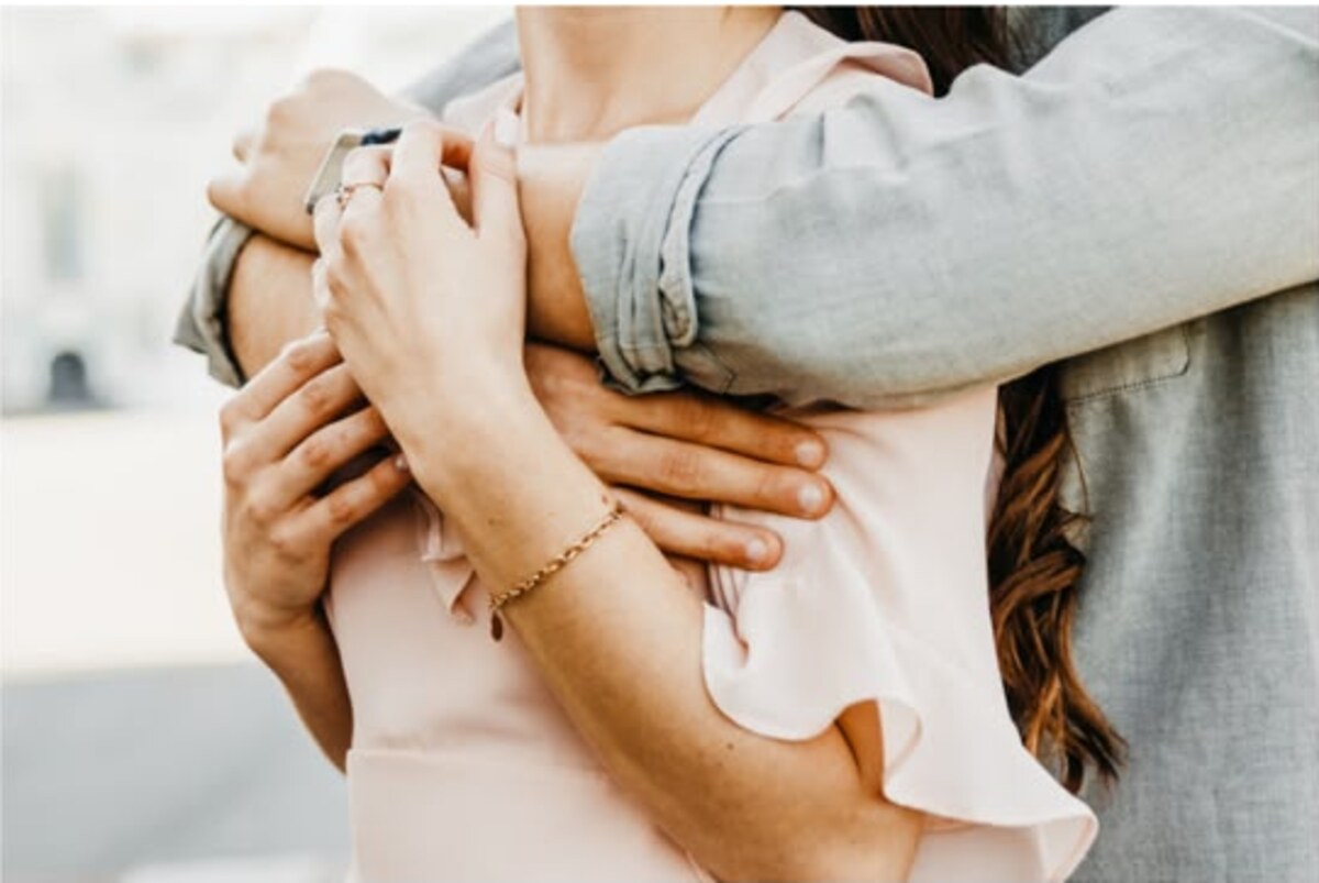 Two people holding one another after a constellation session