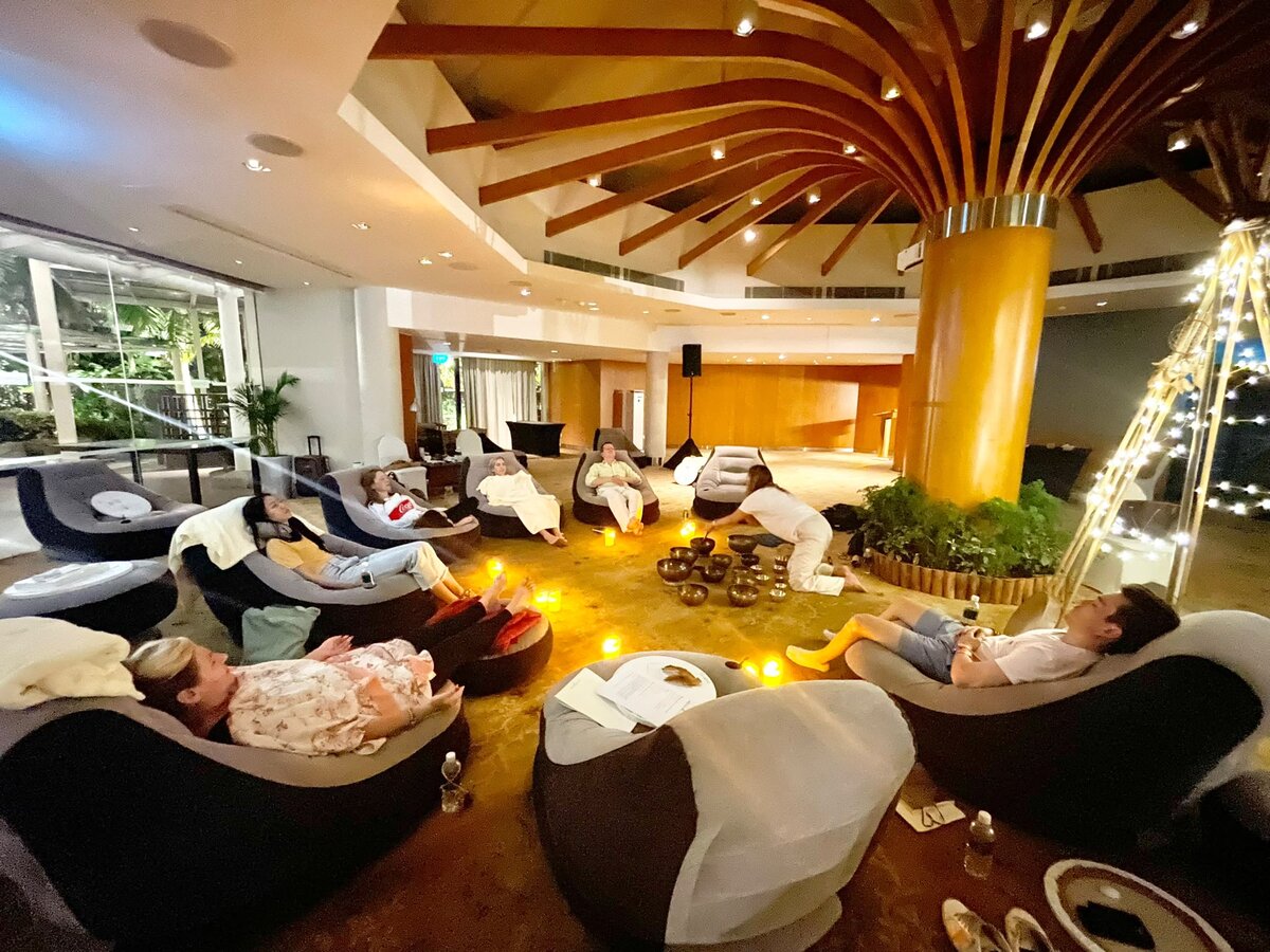 Participants resting in loungers during a group relaxation session